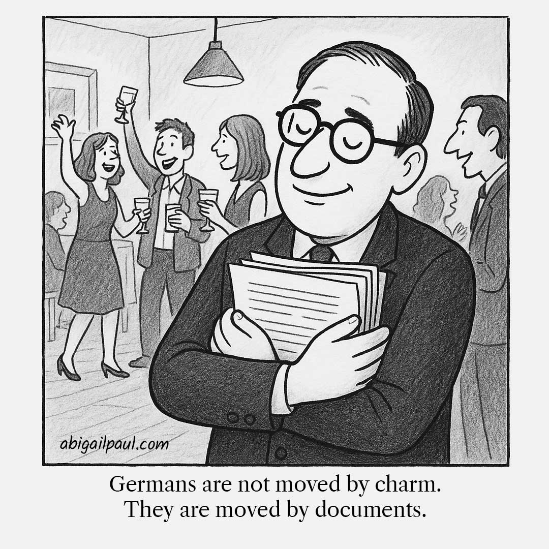 A content German man ignores a lively party to lovingly hug a thick stack of paper documents.